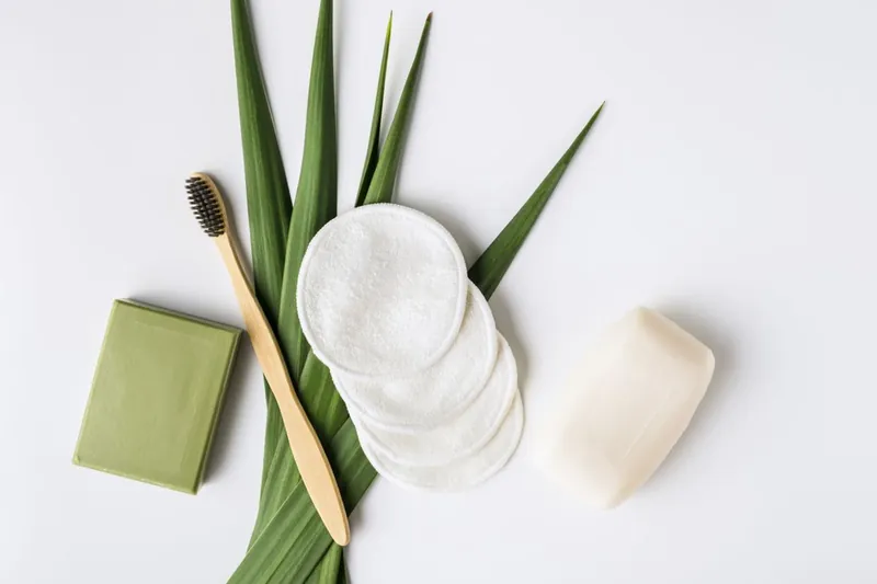 A bamboo toothbrush, reusable cotton pads and a bar of soap