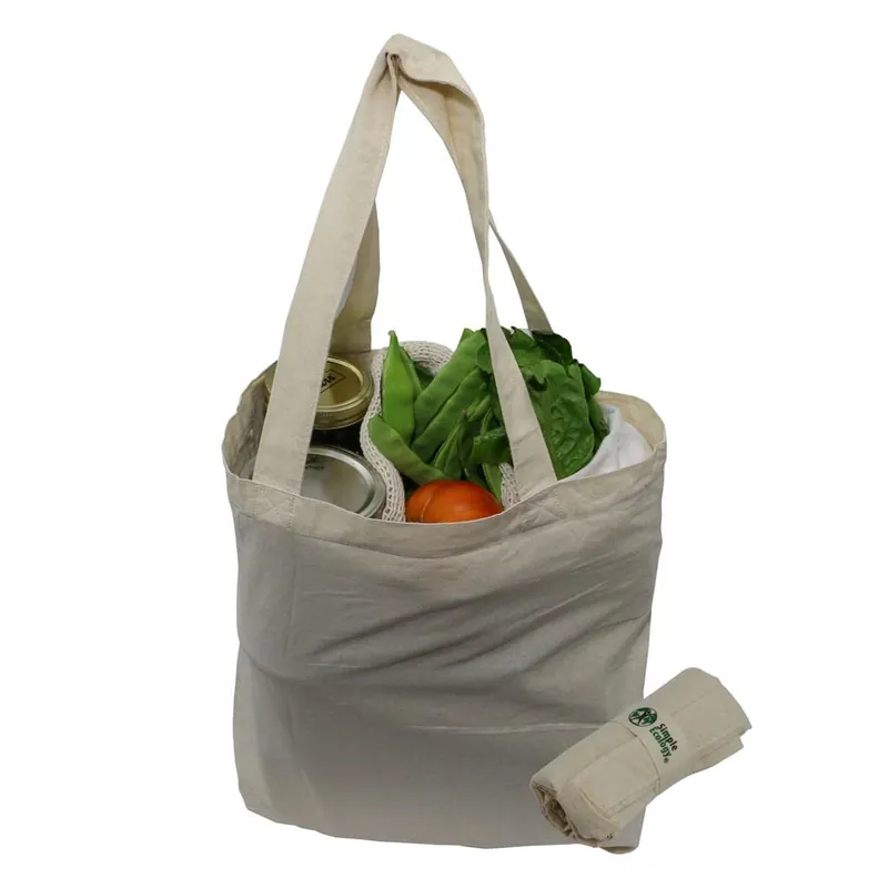 A grey reusable produce bag filled with vegetables